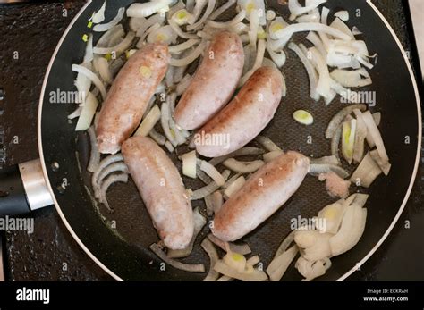 Sausage And Onions Cooking In A Frying Pan Stock Photo Alamy