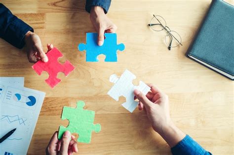 Premium Photo Directly Above Shot Of Cropped Hands Holding Jigsaw