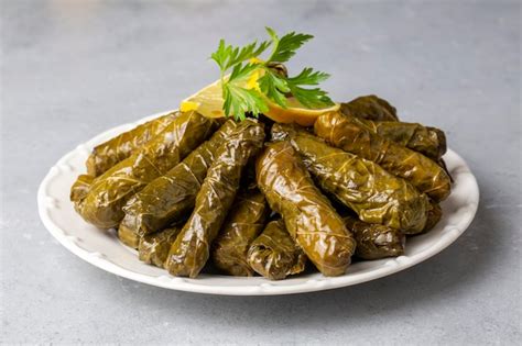 Premium Photo | Delicious dolma sarma stuffed grape leaves rice white yogurt sauce Lebanese ...