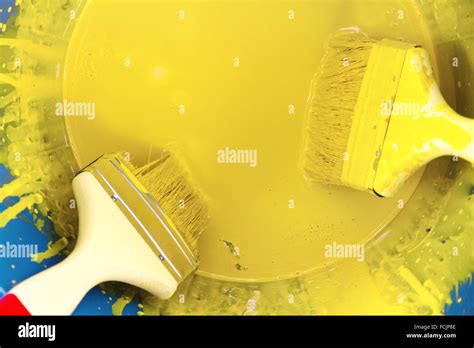 Yellow Paint Can And Brush Stock Photo Alamy