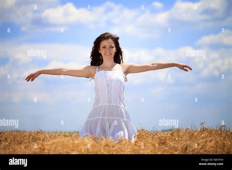 Woman With Arms Stretched Out In Wheat Field Stock Photo Alamy