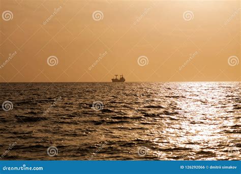 A Cargo Ship in the Sea at Sunset 1 Stock Photo - Image of consumer ...