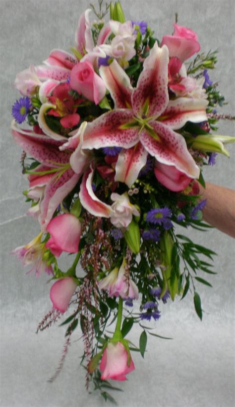 Cascade Bridal Bouquet Features Stargazer Lilies And Pink Roses