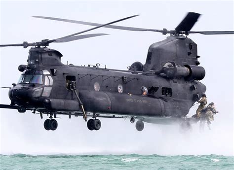 Soldiers fly in an Army MH-6 helicopter during a special operations ...