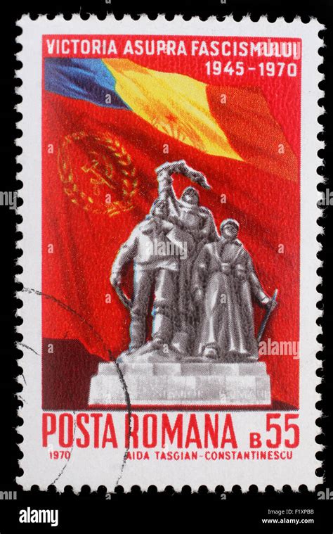 Stamp Printed In Romania Shows Victory Monument And Flags Of Romania