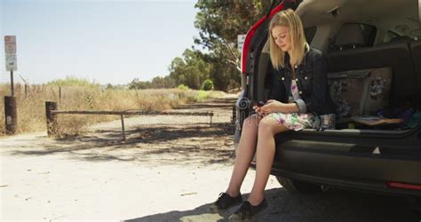 Blonde Woman Sitting In The Back Of Her Car Texting Stock Footage Video Of Pink Casual