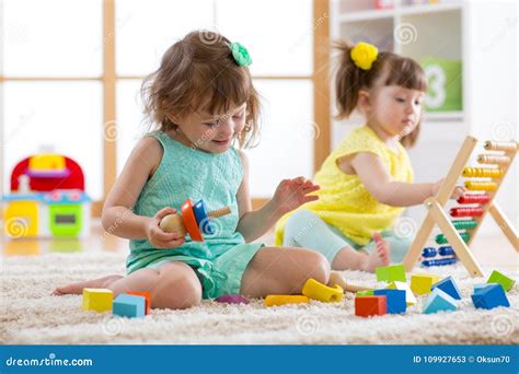 Kids Are Engaging In Daycare Two Toddler Children Playing With