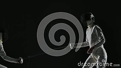 Side View Of Professional Fencers Demonstrating Mastery Of Foil Fencing