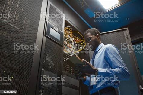 African American Network Engineer In Server Room Stock Photo Download