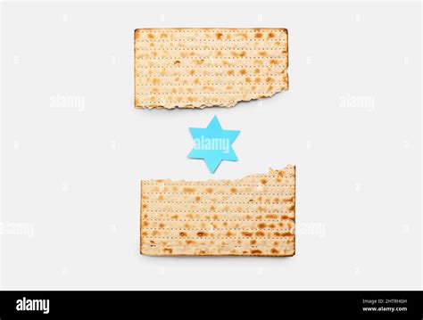 Torn Jewish Flatbread Matza For Passover With Paper David Star On Light