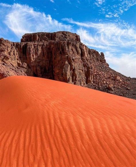 The Desert Is Covered In Red Sand And Rocks