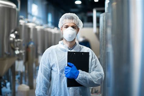 Free Photo Technologist With Protective Mask And Hairnet Standing At