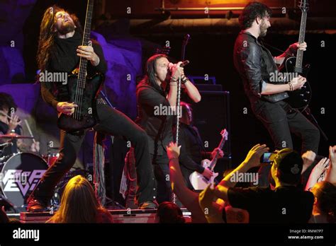 Pop Evil band members are shown performing on stage during "live ...