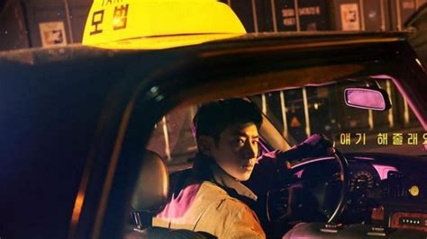 A Woman Sitting In The Driver S Seat Of A Car With A Taxi Cab