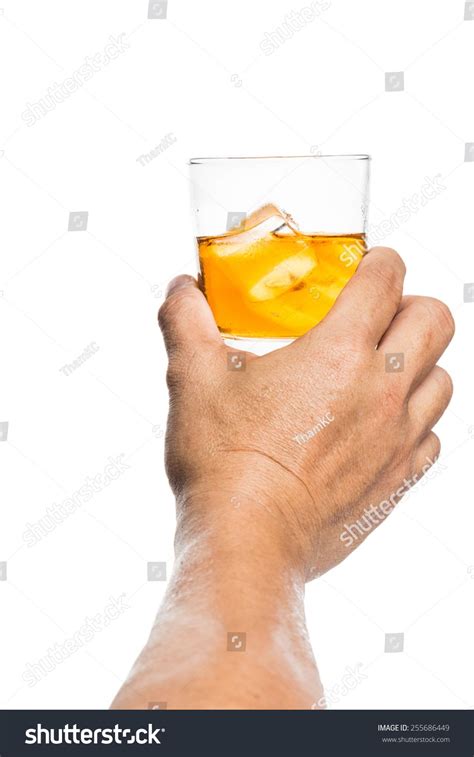 Hand Holding A Glass Of Whiskey On The Rock Imagens Vetoriais