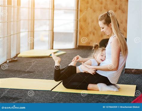 Mom And Daughter Together Perform Different Exercises Stock Image