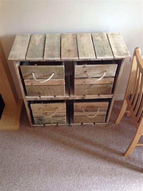 A Wooden Table With Drawers Sitting On Top Of Carpeted Floor Next To A