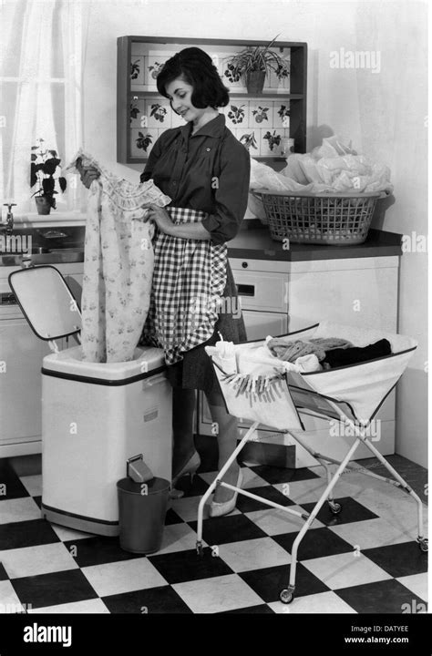 Household Washing Housewife Drying Her Laundry In The Spin Dryer