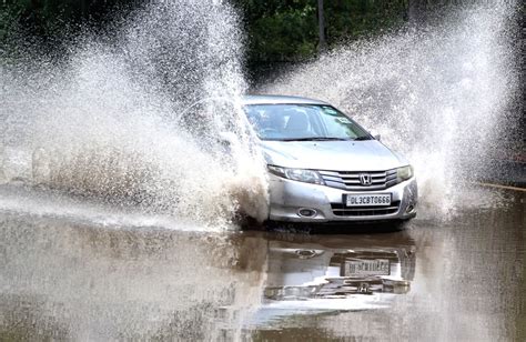 Water Splash As Car Passing Through The Logged Water At Bhairon Marg