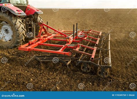 Farmer In Tractor Preparing Land With Seedbed Cultivator Stock Photo