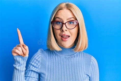 Young Blonde Woman Wearing Casual Clothes And Glasses Showing And