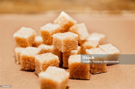 Brown Sugar Cubes Close Up On Brown Paper Background Stock Photo