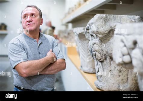 Interested Mature Man In Museum Hall Of Ancient Sculpture Stock Photo Alamy