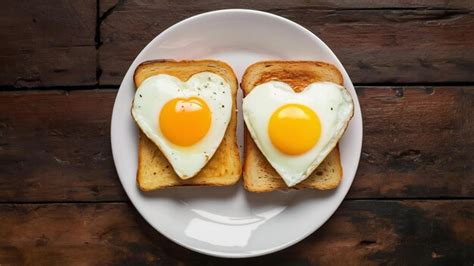 Premium Photo Two Heart Shaped Fried Eggs And Fried Toast