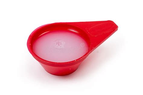 Liquid Laundry Detergent In Measuring Spoon On A White Background Stock