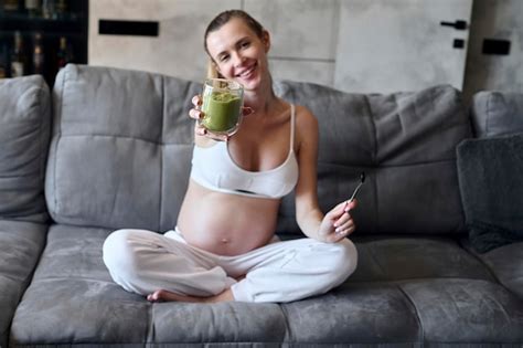 Premium Photo Pregnant Woman Eating A Smoothie In The Living Room