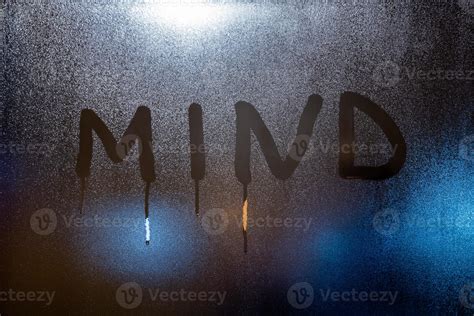 The Word Mind Written On Night Wet Window Glass Close Up With Blurred