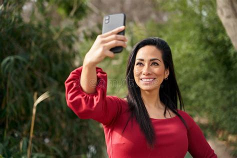 Smiling Hispanic Woman Taking Selfie On Street Stock Image Image Of