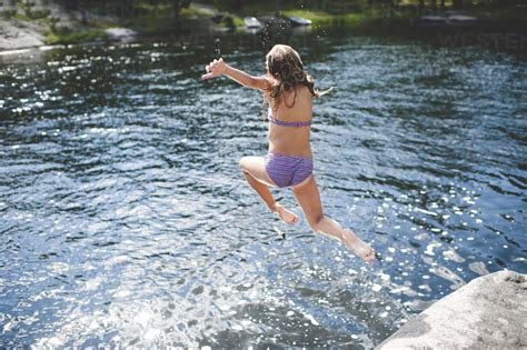 Girl In Bikini Jumping Into Water Kings Lake Ontario Canada Stock Photo