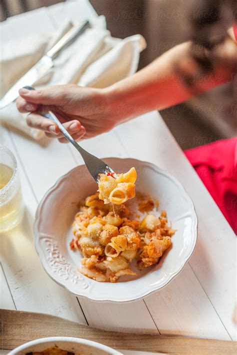 Woman Eating Pasta By Stocksy Contributor Davide Illini Stocksy