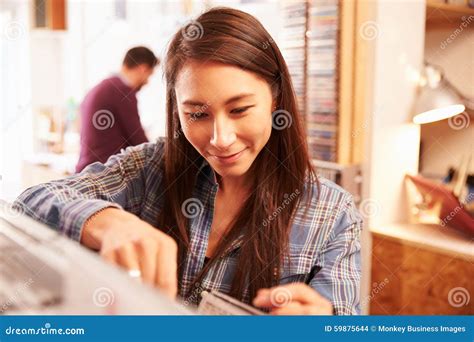 Woman Looking Through Records At A Record Shop Stock Photo Image Of