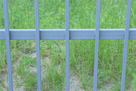 Gray Metal Texture Of Iron Rods On A Background Of Green Grass Stock