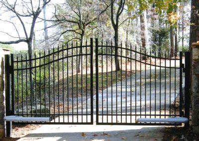 An Iron Gate In The Middle Of A Wooded Area