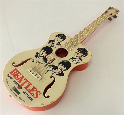 A Beatles Toy Guitar By Selco Circa 1964 Fitted With Original Strings And With Intact Body Deco