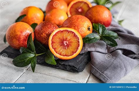 Sliced And Whole Ripe Juicy Sicilian Blood Oranges With Leaves On Black