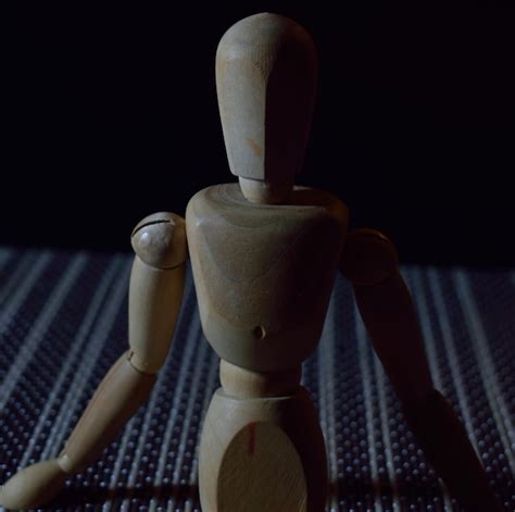 Premium Photo Close Up Of Wooden Figurine Against Black Background