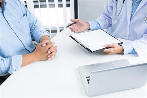 Premium Photo Close Up Of Patient And Consultant Doctor Give An