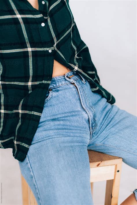 Closeup Of Young Woman Sitting In Blue Jeans And Green Shirt By