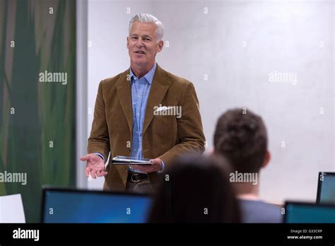Handsome Mature Teacher And Students In Computer Lab Classroom Stock Photo Alamy
