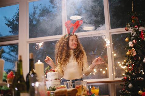 Happy woman in deer antlers with Bengal lights · Free Stock Photo