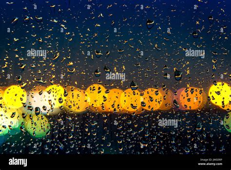 raindrops on window with bokeh of light Stock Photo - Alamy