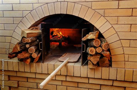 Traditional Pizza oven, burning wood and flames in fireplace. Arabic ...