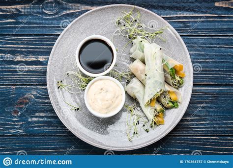 Delicious Rolls Wrapped In Rice Paper Served On Blue Wooden Table Top View Stock Image Image