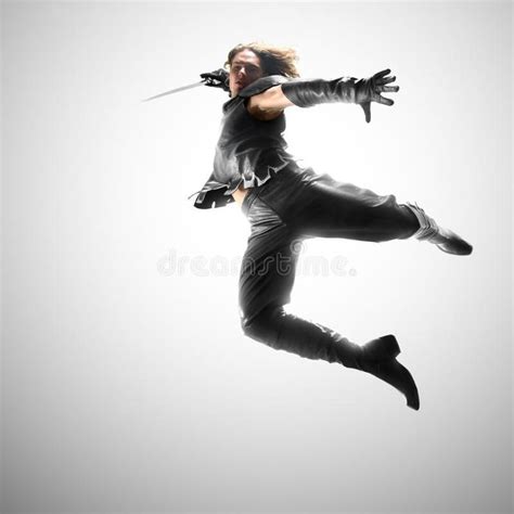 Photo about Man jumping with a sword in a suit of the warrior. Image of ...