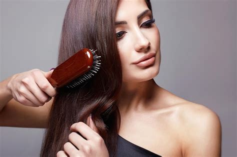 Premium Photo Beautiful Girl Combing Her Hair Beautiful Hair Care