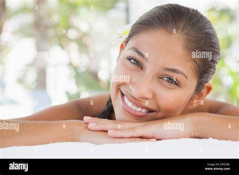 Beautiful Brunette Relaxing On Massage Table Smiling At Camera Stock Photo Alamy